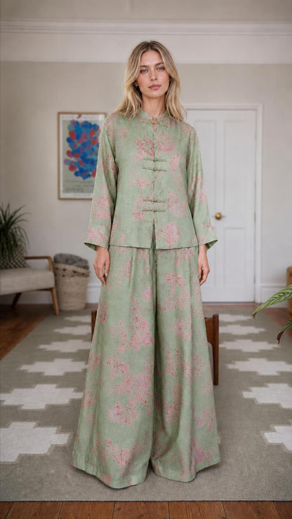 Front view of woman wearing green floral brocade set