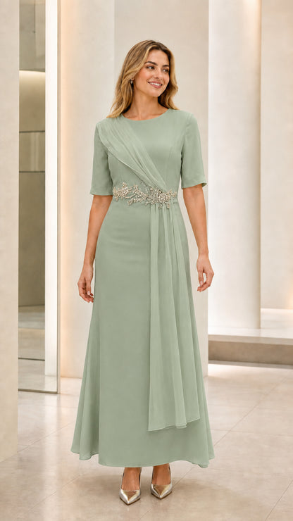 Front view of model wearing sage green short sleeve formal dress with crystal applique