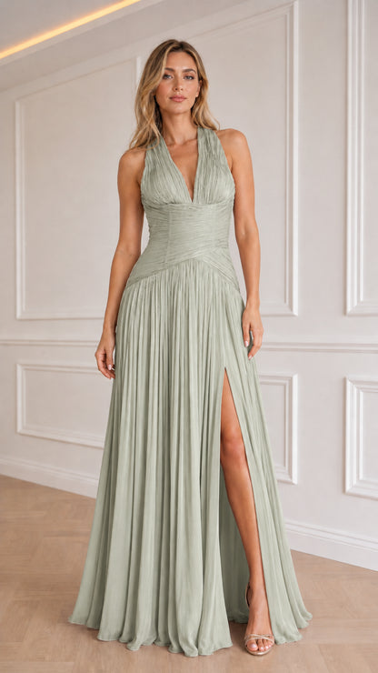 Model wearing sage green color variant of the halter pleated evening dress