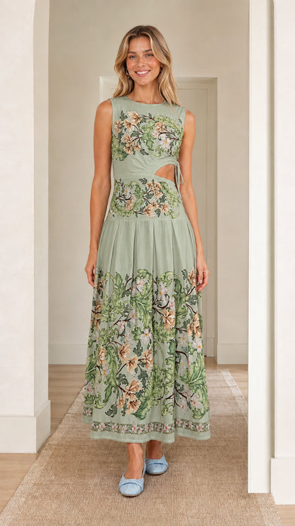 Woman wearing sage green floral print cutout maxi dress