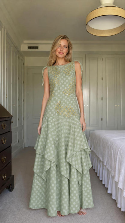 Model wearing sage green polka dot tiered maxi dress