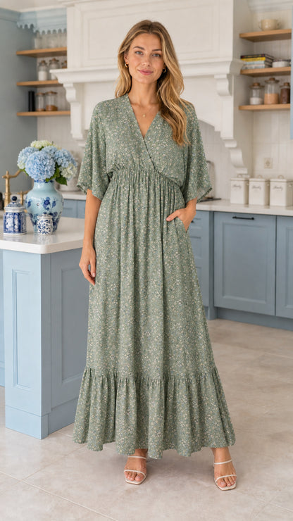 Front view of model wearing sage green floral tiered maxi dress with pockets
