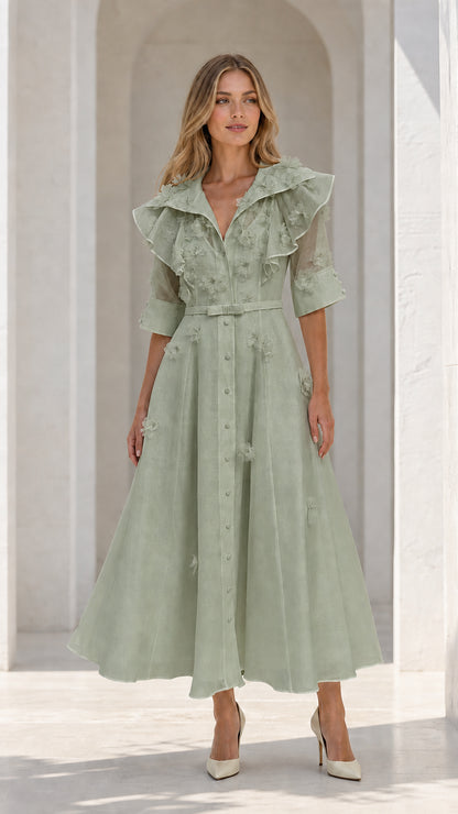 Model wearing sage green floral applique ruffle midi dress