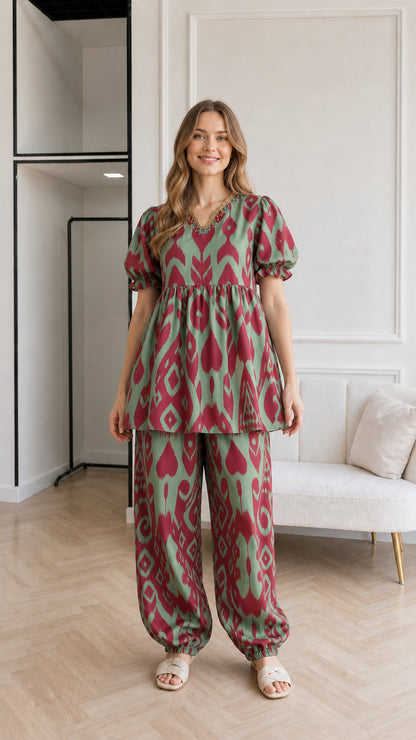 Woman wearing Sage Green and red printed babydoll tunic top and cuffed pants set