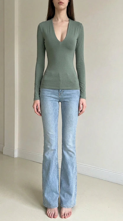 Front view of woman wearing sage green deep v-neck long sleeve top