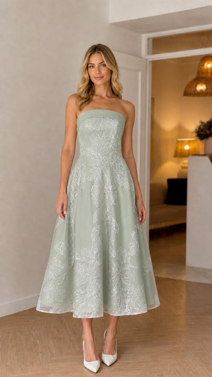 Model wearing sage green strapless floral embroidered midi dress