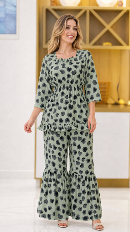 Sage green floral print 2-piece smocked pant set on model