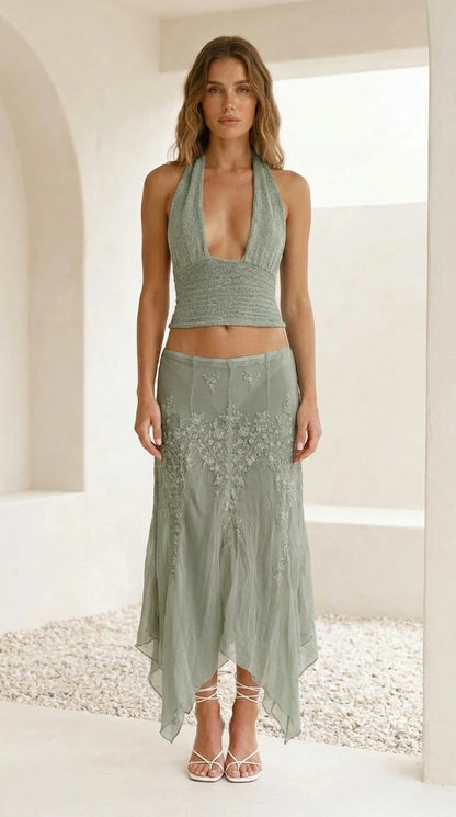 Model wearing sage green embroidered halter crop top and skirt set