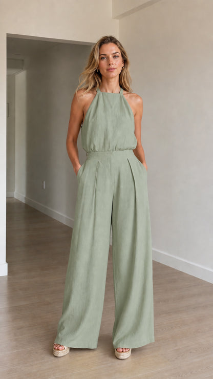 Model wearing sage green halter neck jumpsuit