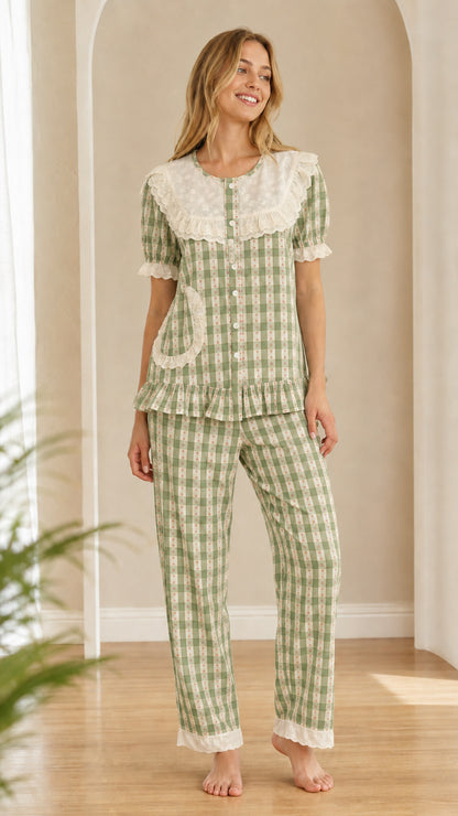 Model wearing sage green gingham sleepwear set with embroidered collar