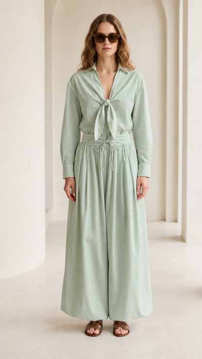 Woman wearing sage green tie-front shirt and wide-leg pants set