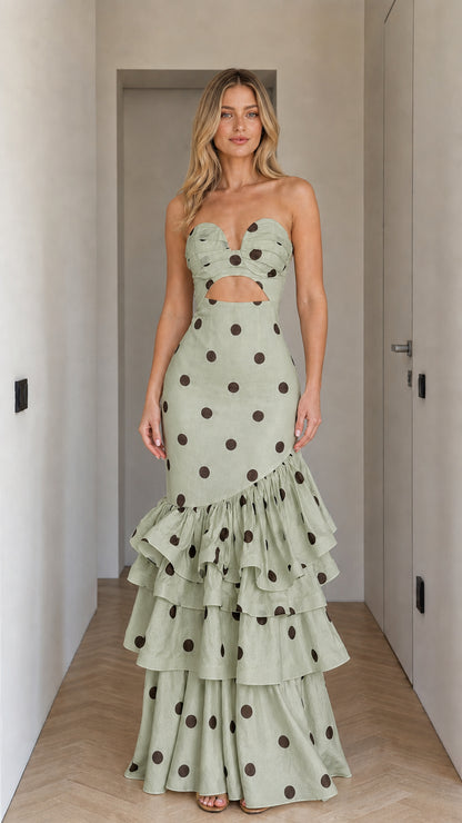 Front view of woman wearing sage polka dot strapless cutout ruffle maxi dress