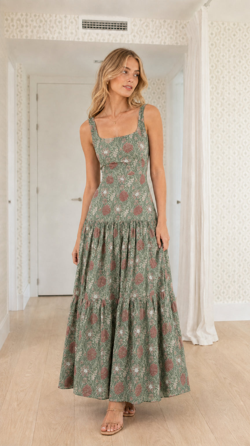 Front view of model wearing sage green floral tiered maxi dress