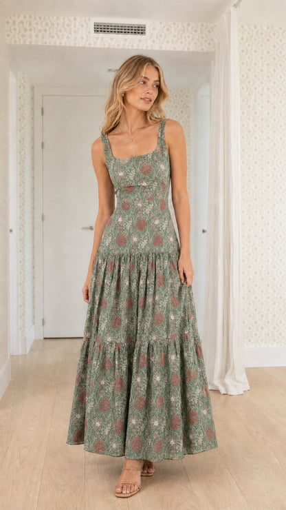 Front view of model wearing sage green floral tiered maxi dress