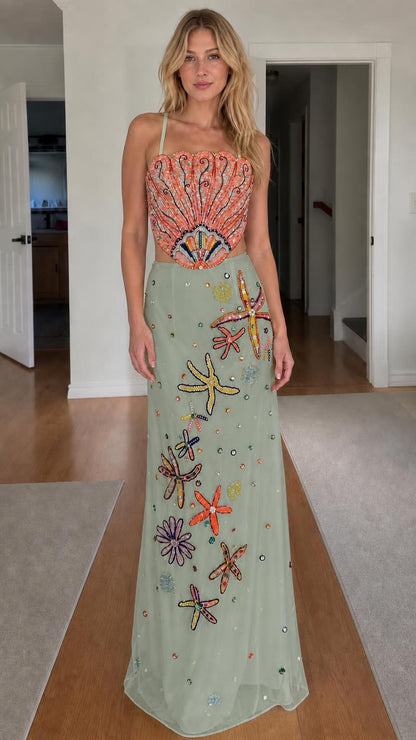Model wearing sage green color variant of beaded seashell two-piece dress