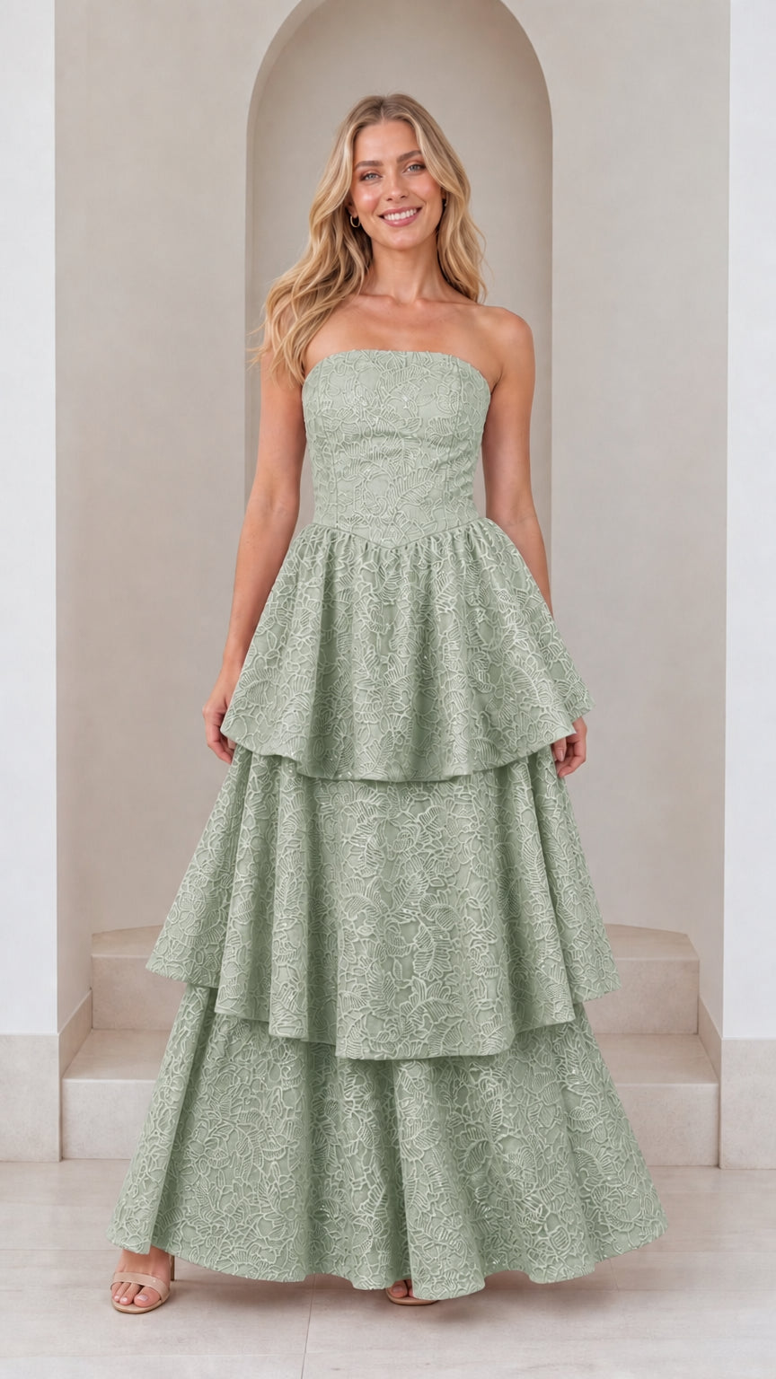 Front view of model in sage green strapless tiered maxi dress