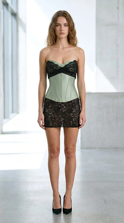 Front view of sage green satin bustier and black lace mini skirt set