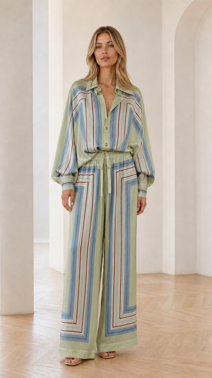 Model wearing sage green geometric striped two-piece set