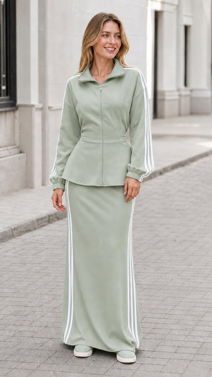 Woman wearing sage green zip-front jacket and matching long maxi skirt set