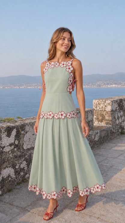 Woman wearing sage green variant of the embroidered floral midi dress