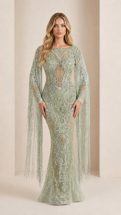 Model wearing sage green sequin and beaded mermaid gown with long sleeve fringe