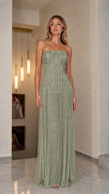 Front view of model in sage green strapless beaded fringe gown