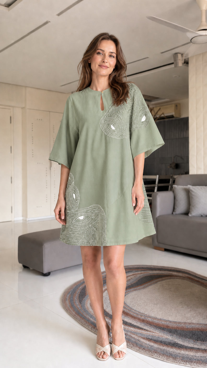 Model wearing sage green shift dress