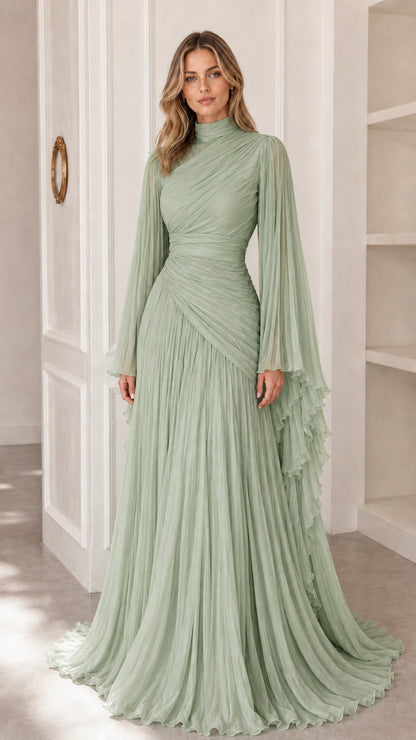 Model wearing sage green pleated high neck evening gown with cape sleeves