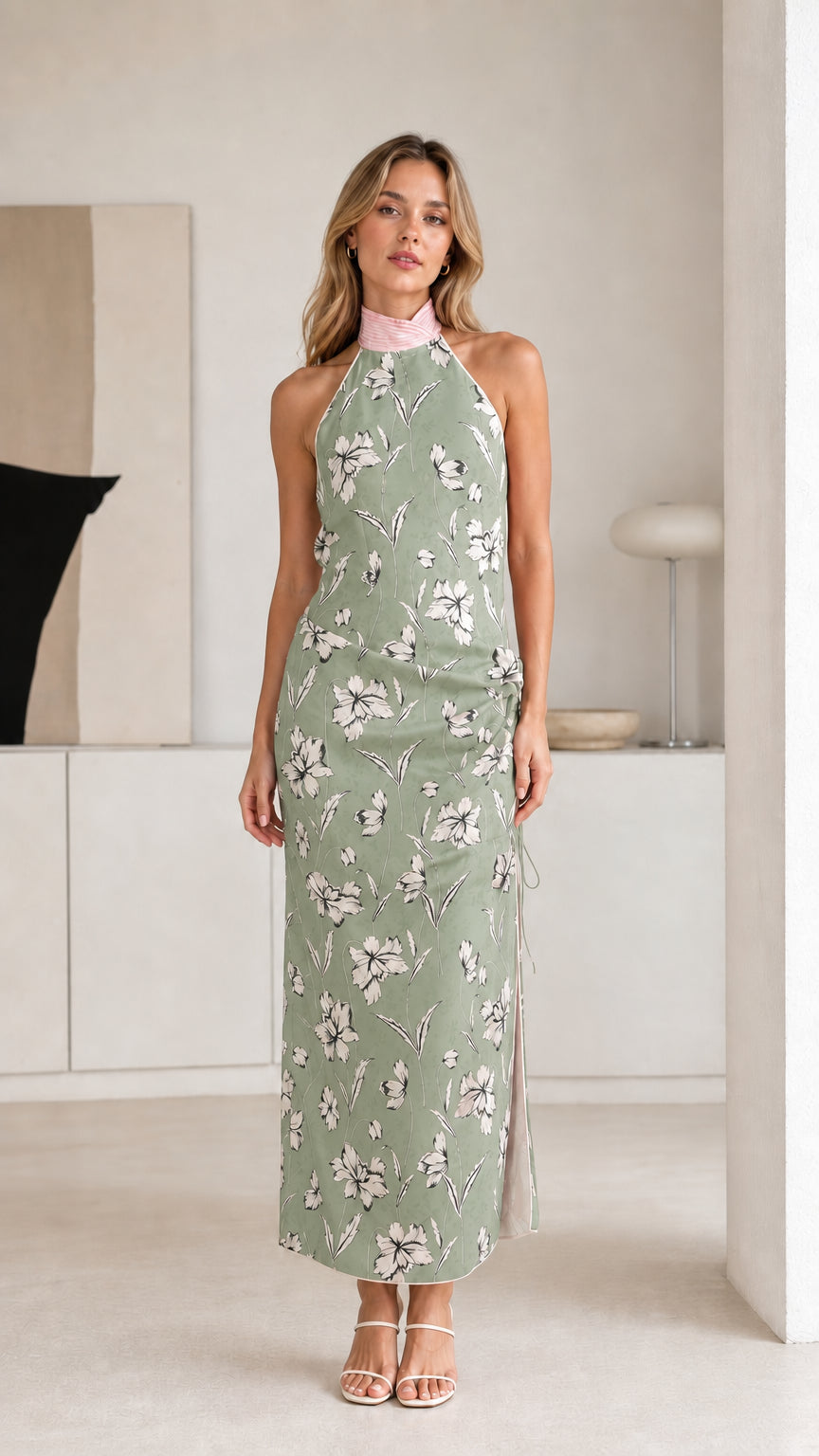 Woman wearing sage green floral halter maxi dress