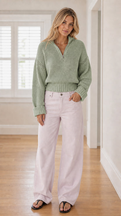Model wearing sage green half-zip knit sweater