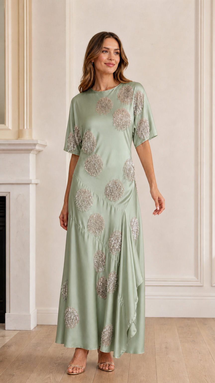 Model wearing sage green sequin polka dot satin maxi dress