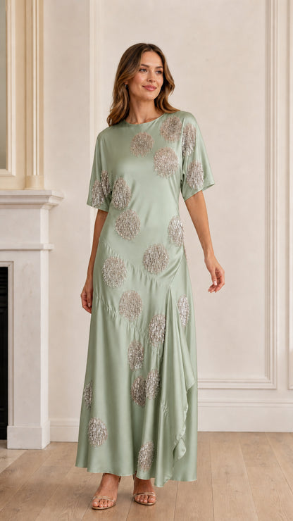 Model wearing sage green sequin polka dot satin maxi dress