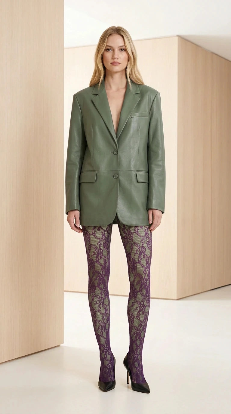 Front view of model wearing the sage green faux leather tailored blazer