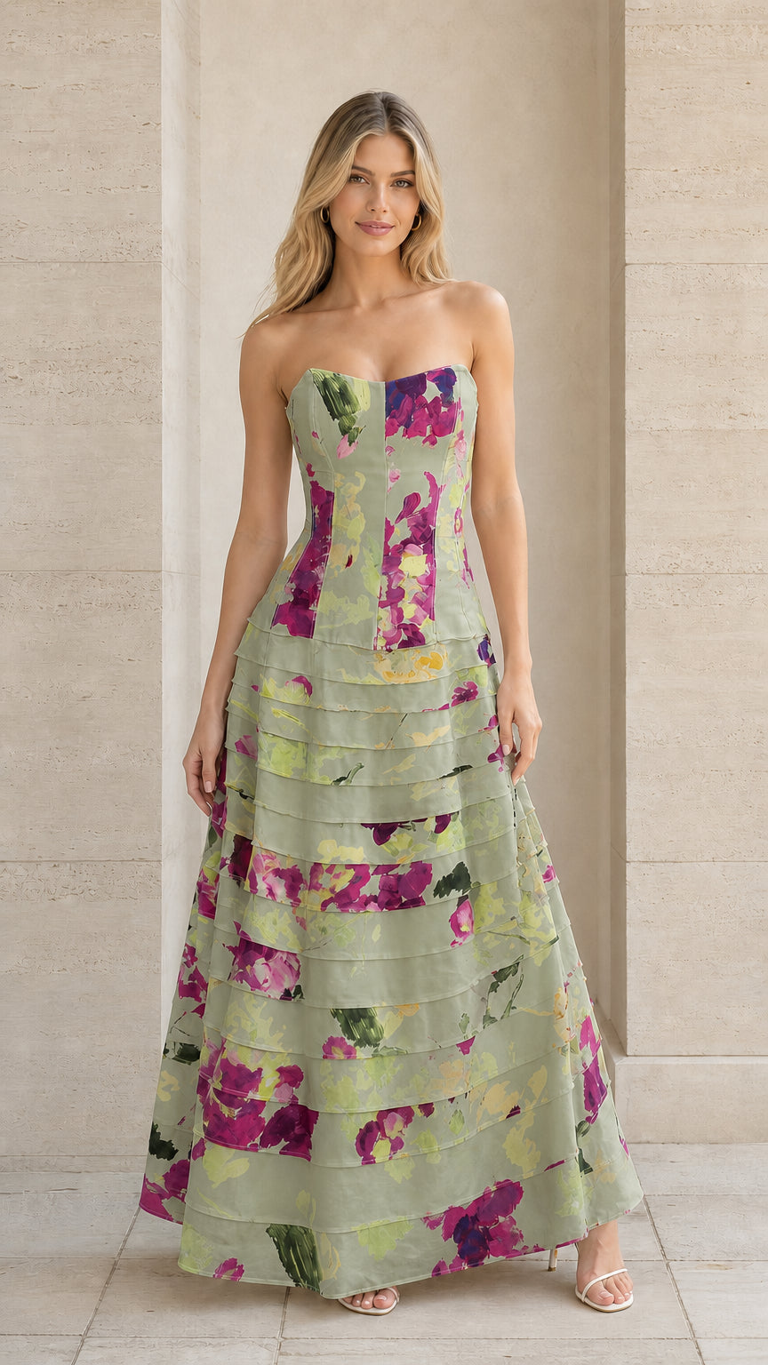 Model wearing sage green floral strapless tiered A-line gown
