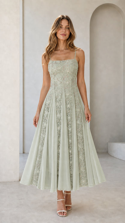 Front view of sage green floral embroidered midi dress on model