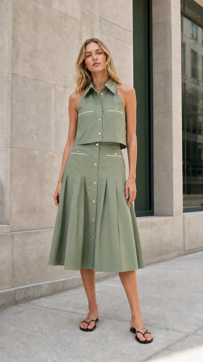 Sage green sleeveless collared top and pleated midi skirt set shown from the front