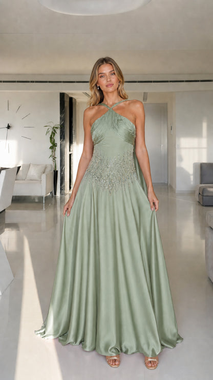 Model wearing sage green halter neck satin maxi dress
