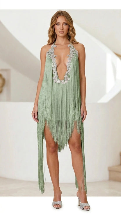 Model wearing sage green fringe halter mini dress
