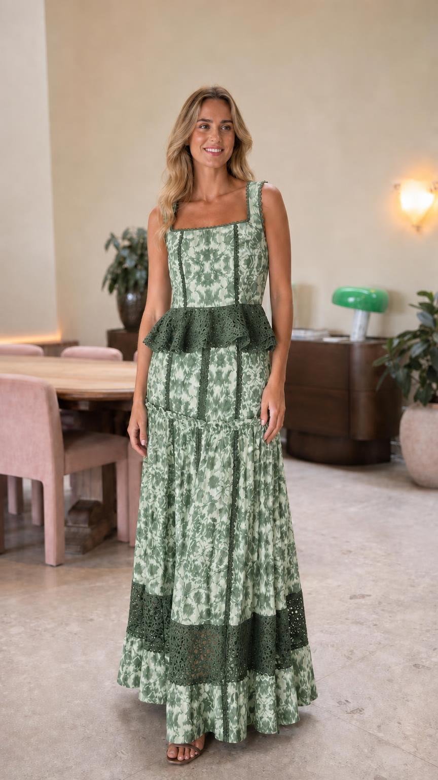 Front view of woman wearing green lace trim maxi dress