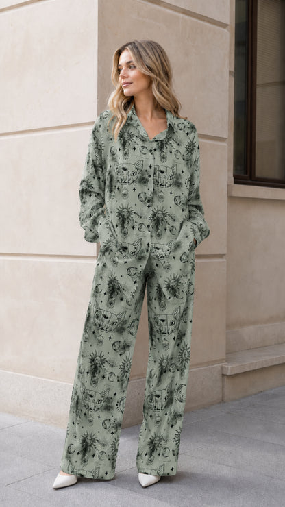 Woman wearing sage green celestial print long sleeve pajama set