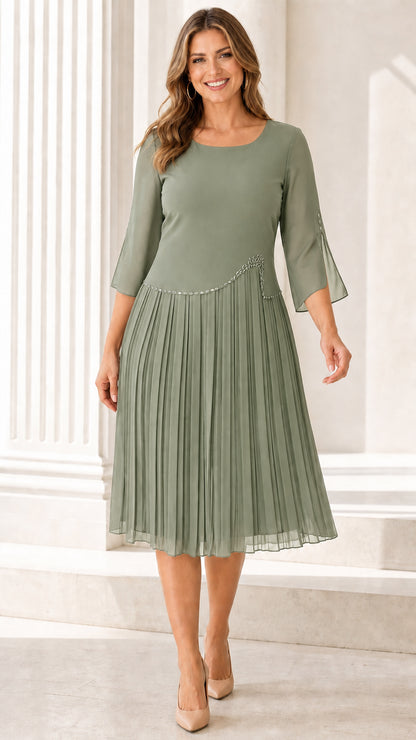 Full front view of model wearing the Sage Green pleated midi dress with sheer sleeves
