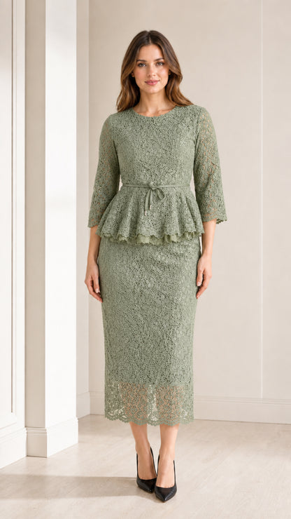Front view of woman wearing sage green lace peplum midi dress