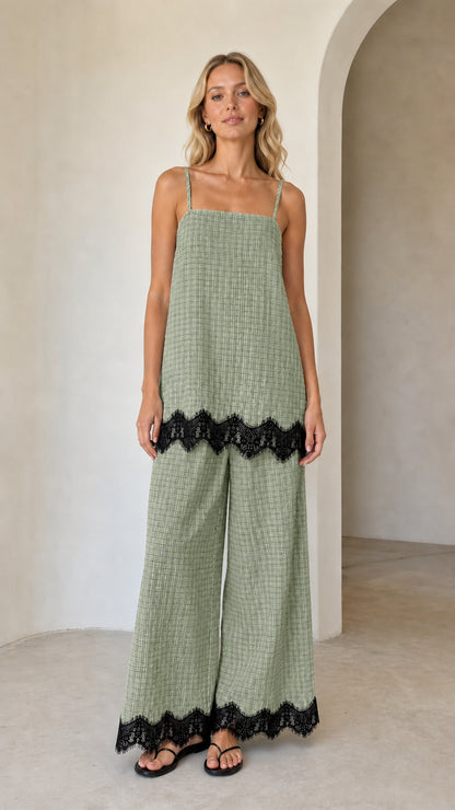 Model wearing sage green plaid two-piece set with black lace hem