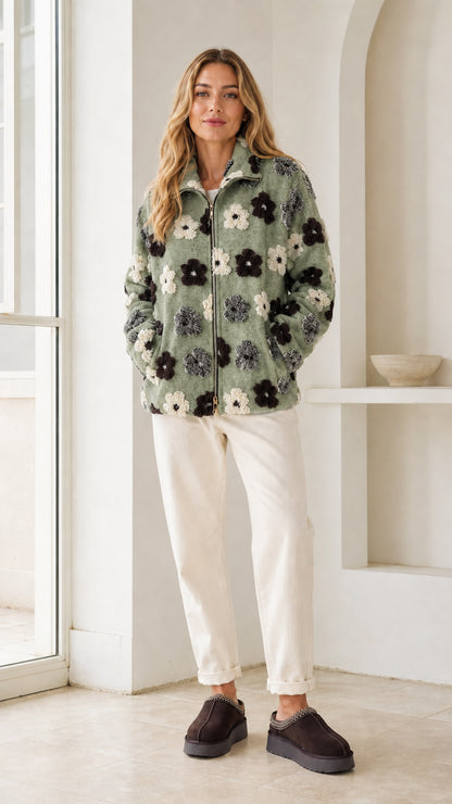 Model wearing sage green floral sherpa fleece zip jacket
