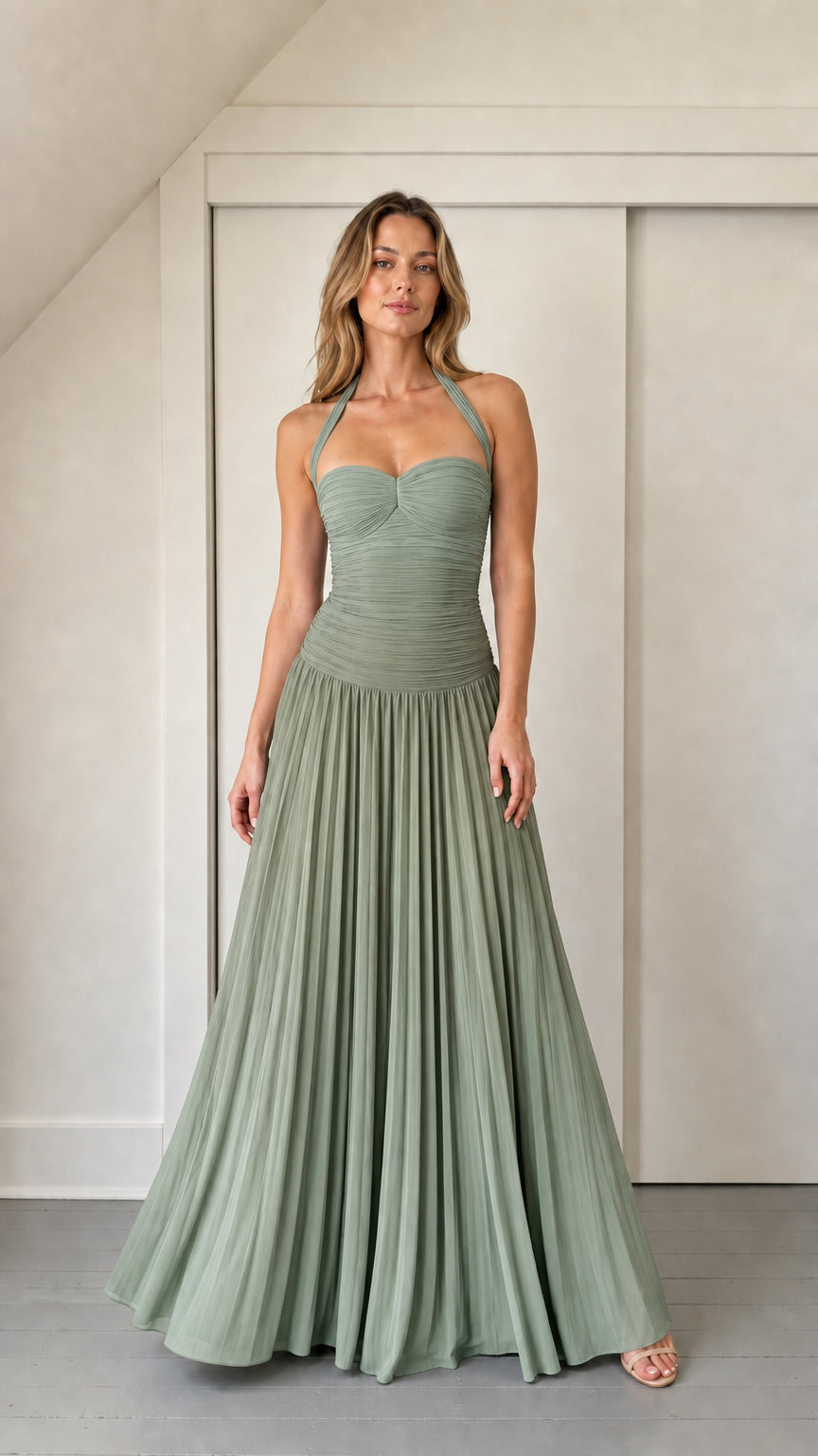 Model wearing sage green ruched halter maxi dress
