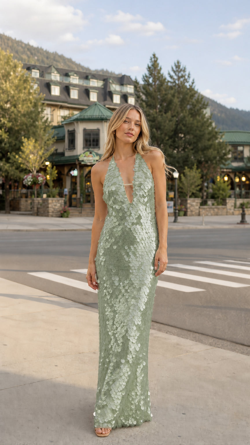 Woman wearing sage green sequin halter maxi dress