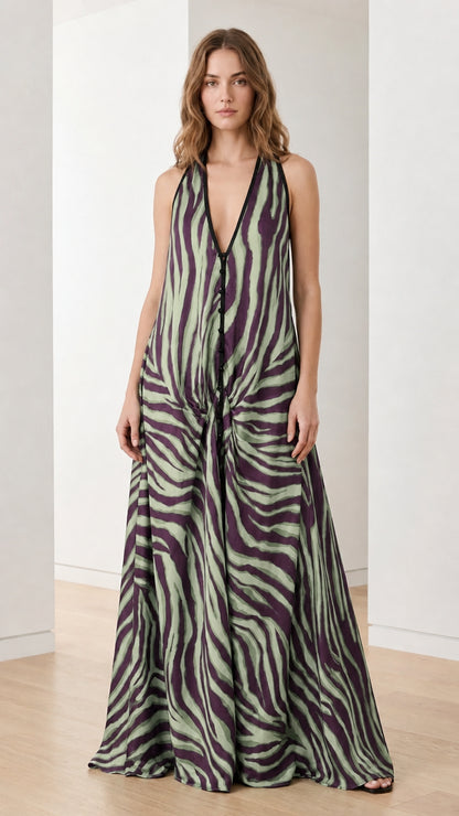 Woman wearing green and purple zebra print halter maxi dress