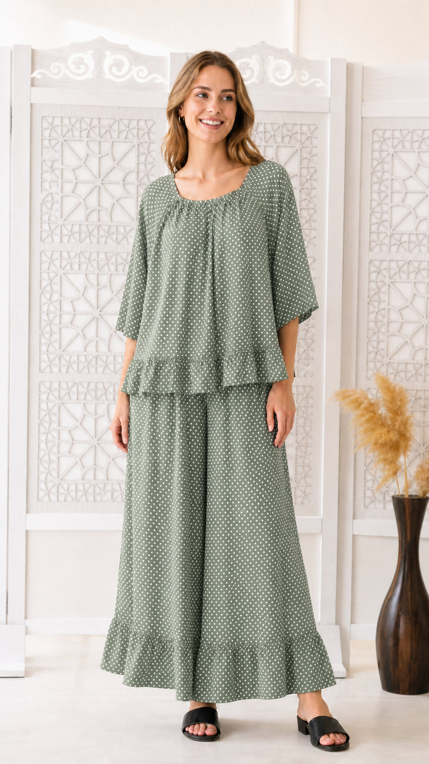 Front view of woman wearing sage green polka dot two-piece matching set