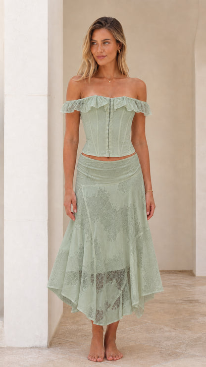 Woman wearing sage green off-shoulder lace corset top and midi skirt set
