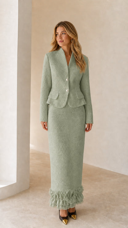 Model wearing sage green tweed blazer and maxi skirt set